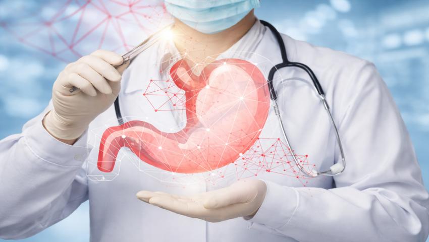 Paediatric GI & Digestive Conditions Symptoms Treatment Options Doctor explaining pediatric gastrointestinal and digestive conditions with stomach illustration